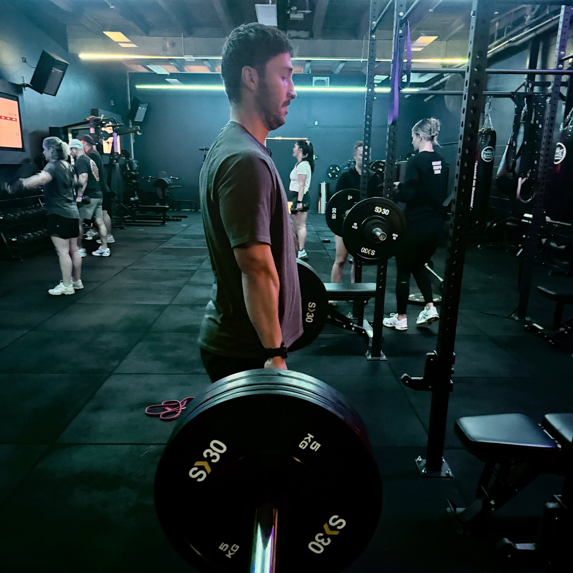 A member holding a loaded barbell during a deadlift